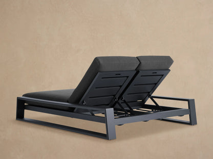 Close-up of Canyon Outdoor Aluminum Double Chaise with dark grey cushion on a matte dark grey angular aluminum frame, viewed from above.