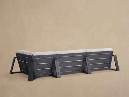 Close-up of Canyon Outdoor Aluminum Three-Piece Sectional with light gray textured cushions on a dark aluminum frame.