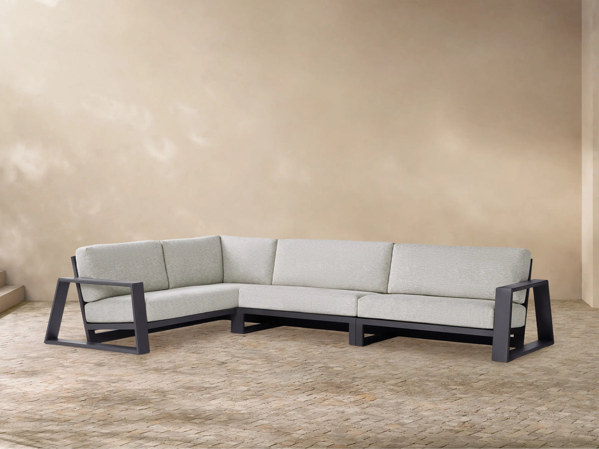 Modern L-shaped Canyon Outdoor Aluminum Three-Piece Sectional with dark gray frame & light gray cushions, on a patterned patio.
