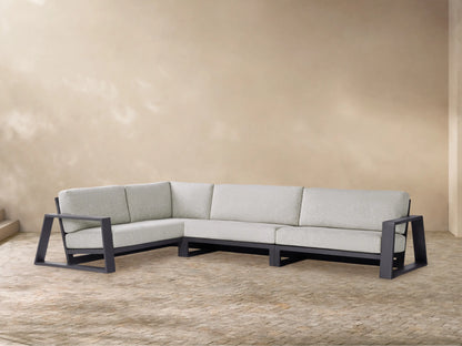 Modern L-shaped Canyon Outdoor Aluminum Three-Piece Sectional with dark gray frame & light gray cushions, on a patterned patio.