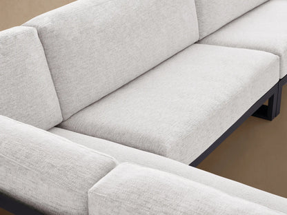 Canyon Outdoor Aluminum Three-Piece Sectional, L-shaped with dark gray frames & light gray cushions, shown on a patio.
