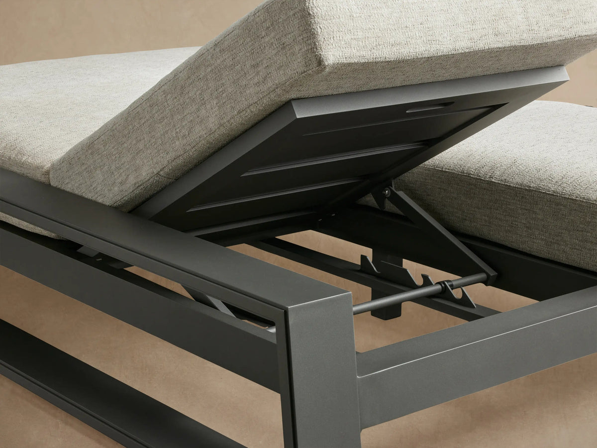 Side view of Canyon Outdoor Aluminum Double Chaise with dark gray frame and light gray cushions, one backrest raised.