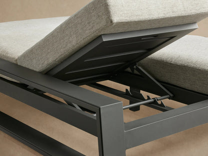 Side view of Canyon Outdoor Aluminum Double Chaise with dark gray frame and light gray cushions, one backrest raised.