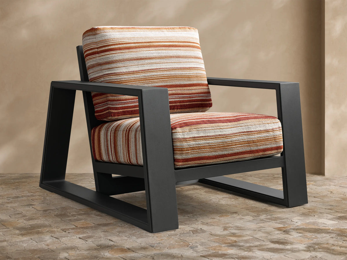Front view of the Canyon Outdoor Aluminum Lounge Chair with dark gray frame and striped red, orange, beige cushions.