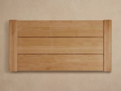 Canyon Outdoor Teak Coffee Table, natural light-colored rectangular table with slatted top and open lower shelf, angled.