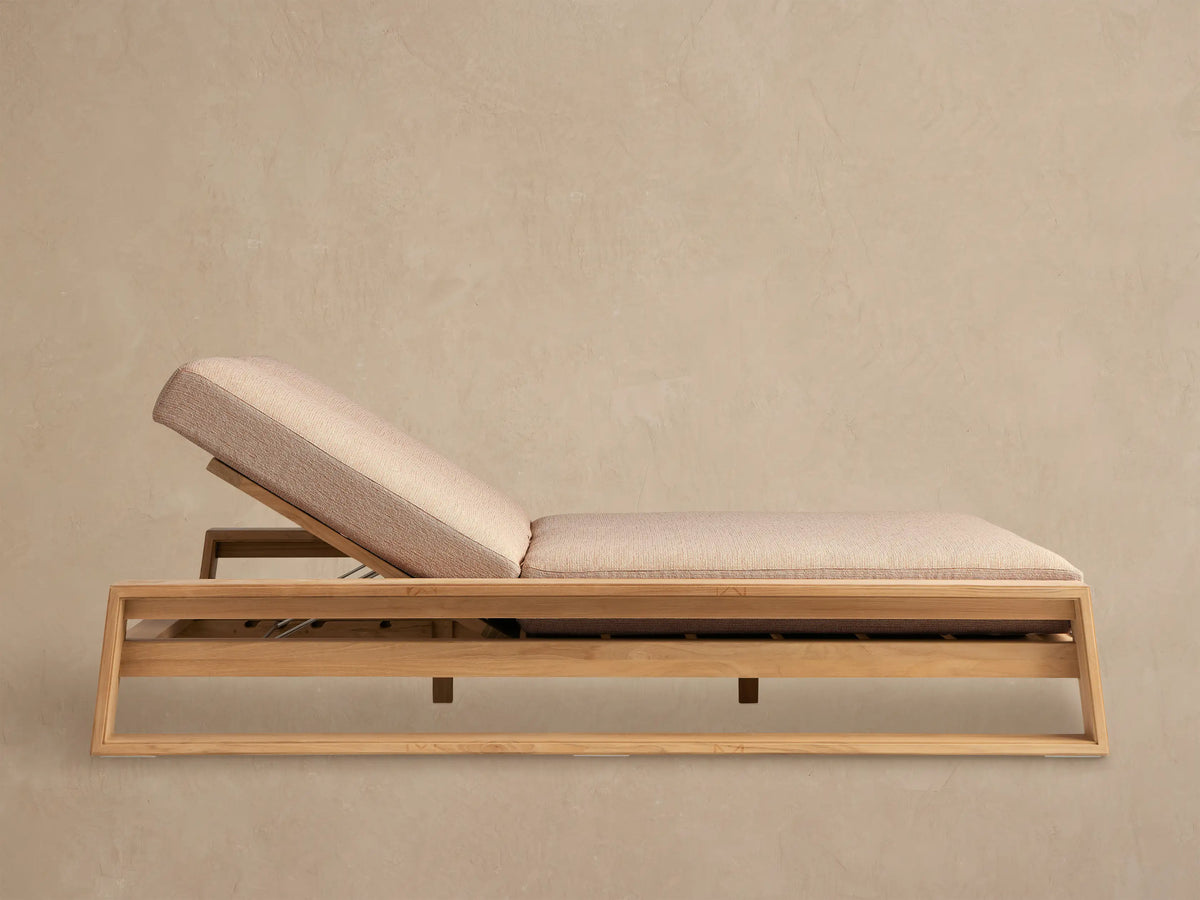 Canyon Outdoor Teak Double Chaise with light beige cushions, both backrests raised, on a tiled patio against a light wall.