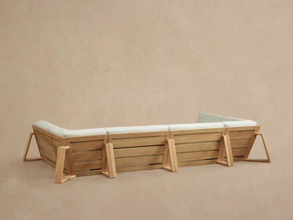Close-up of Canyon Outdoor Teak Four-Piece Sectional, showing natural teak frame and plush cream cushions from a corner view.