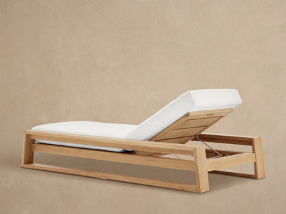 Angled close-up of Canyon Outdoor Teak Chaise's natural teak wood frame and white cushion, revealing its adjustable back mechanism.