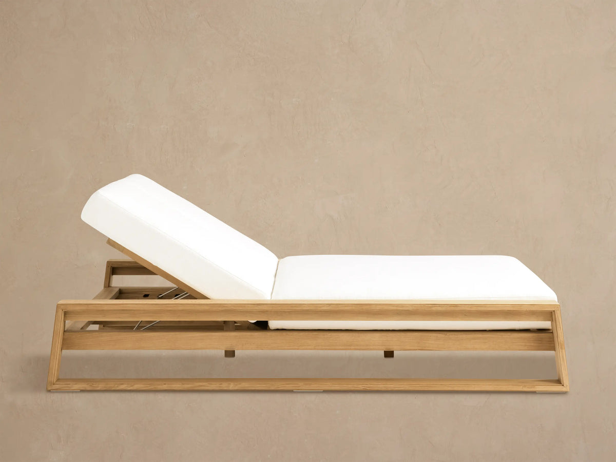 Canyon Outdoor Teak Double Chaise with light brown frame and two white, independently reclined cushions on a tiled patio.