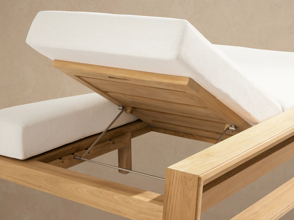 Side view of Canyon Outdoor Teak Double Chaise with light brown frame & white cushions; left backrest is raised.