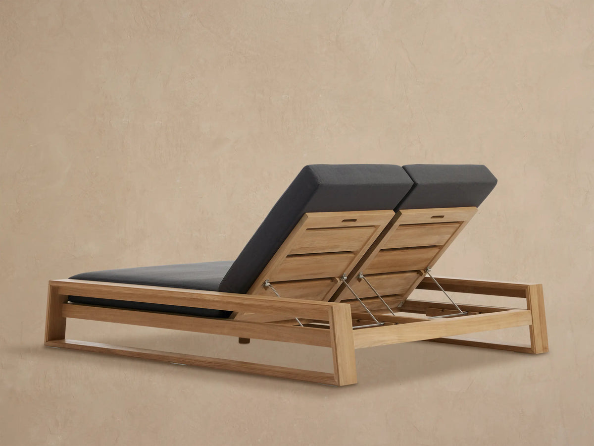 Canyon Outdoor Teak Double Chaise with dark grey cushions, showing adjustable teak backrests supported by metal rods.