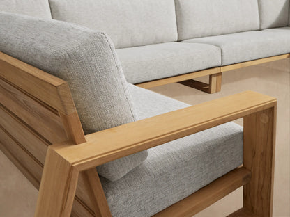 Canyon Outdoor Teak Four-Piece Sectional, L-shaped, with light grey cushions on natural teak wood frame outdoors.
