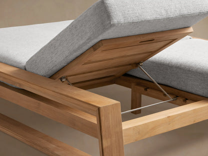 Side view of Canyon Outdoor Teak Double Chaise with light grey cushions. One backrest is raised, the other flat. Teak wood frame.