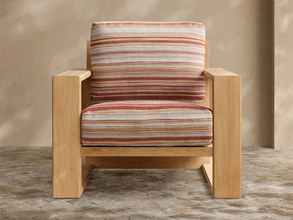 Front view of the Canyon Outdoor Teak Lounge Chair with striped cushions in white, cream, orange, and red.