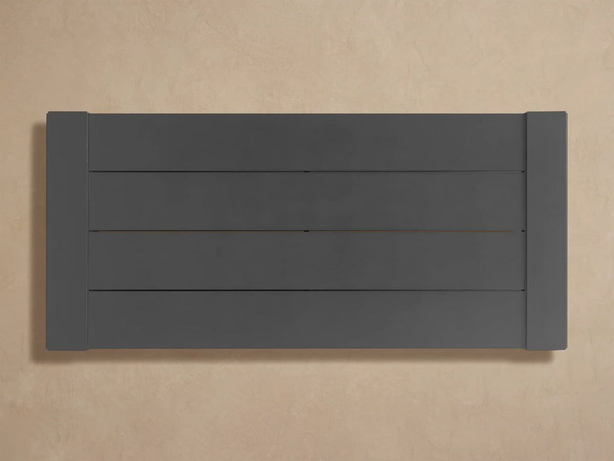 Close-up of the dark gray, matte-finished Canyon Outdoor Aluminum Coffee Table with slatted top and side framing.