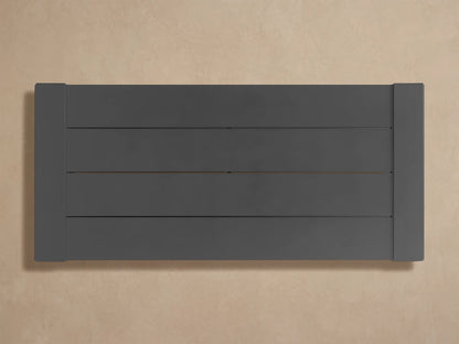 Close-up of the dark gray, matte-finished Canyon Outdoor Aluminum Coffee Table with slatted top and side framing.