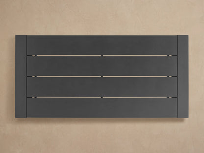 Angled close-up of dark gray Canyon Outdoor Aluminum Dining Table's matte slat top and sturdy side edge.