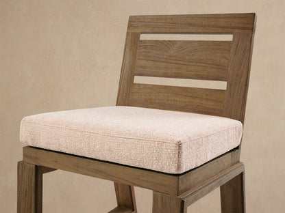 Front view of Canyon Outdoor Teak Dining Side Chair with 2-slat back, light brown distressed finish, light beige cushion.