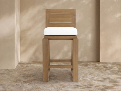 Canyon Outdoor Teak Barstool angled right: light brown teak with square back, white cushion, sturdy legs on mosaic tile.