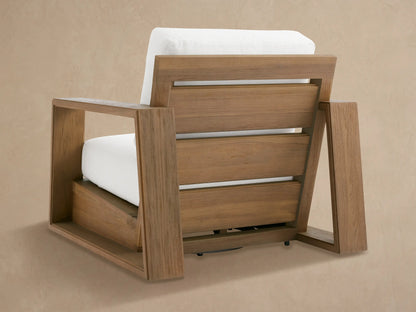 Close-up of Canyon Outdoor Teak Swivel Chair armrest, showing textured brown teak wood frame and plush white cushions.