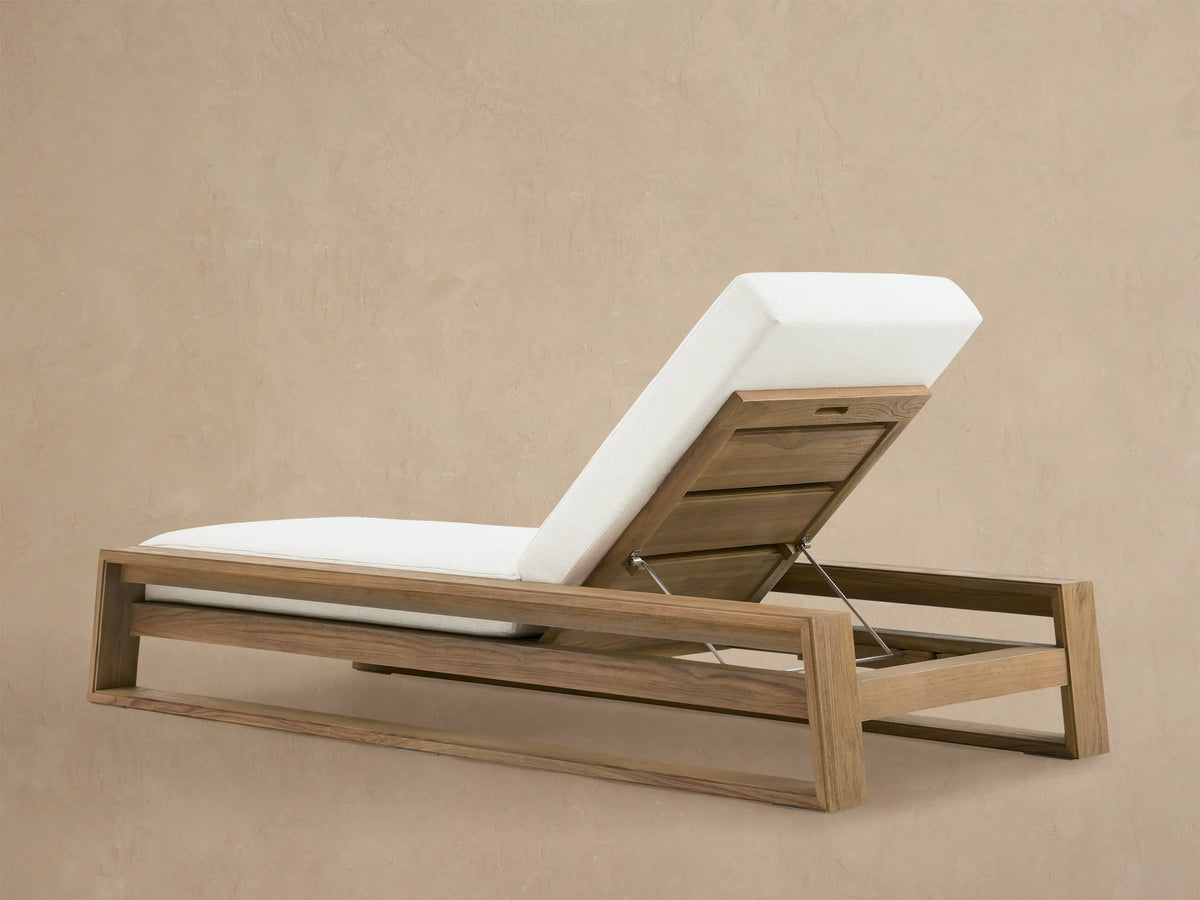 Close-up of Canyon Weathered Fawn Outdoor Teak Chaise back, angled up, showing weathered wood, white cushion, and metal adjustment bar.