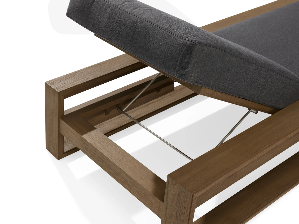 Canyon Outdoor Teak Chaise in natural wood finish with gray cushions, adjustable backrest, side view on white background.