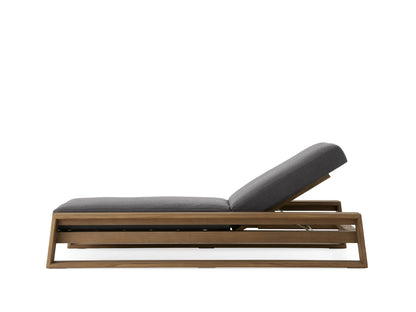 Canyon Outdoor Teak Chaise with a grey cushion, adjustable backrest, and sleek wooden frame, shown in angled view.