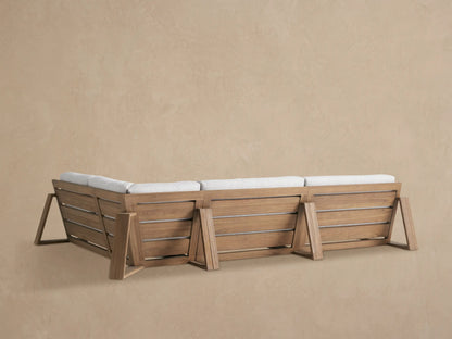 Close-up of Canyon Outdoor Teak Sectional with light gray textured cushion against a weathered teak wood armrest.