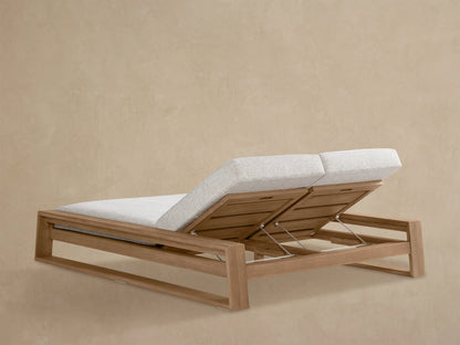 Canyon Outdoor Teak Double Chaise. Close-up shows light grey cushion on raised teak backrest with metal adjustment arm.