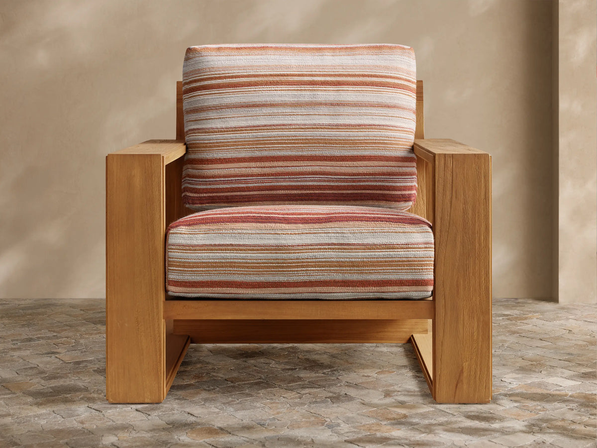 Front view of the natural teak Canyon Outdoor Teak Lounge Chair‚Ñ¢ with multi-colored striped cushions in off-white, tan, and terracotta.
