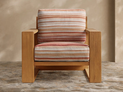 Front view of the natural teak Canyon Outdoor Teak Lounge Chair‚Ñ¢ with multi-colored striped cushions in off-white, tan, and terracotta.