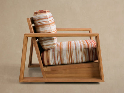 Canyon Outdoor Teak Swivel Chair, angled back view. Honey teak frame, slatted back, with striped orange, white, and beige cushions.