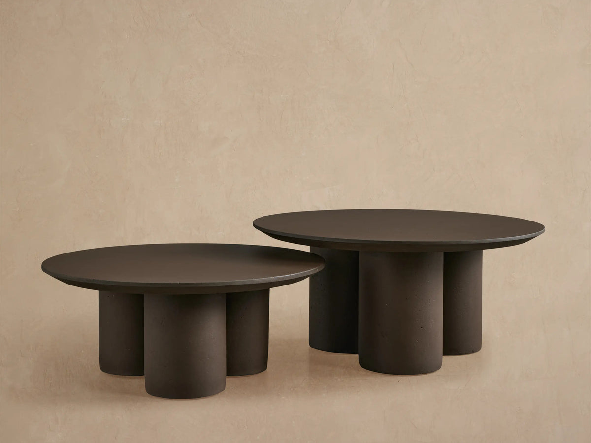 Close-up of Cascade Outdoor Coffee Table, showing its round, dark brown textured top with a reverse-beveled edge.