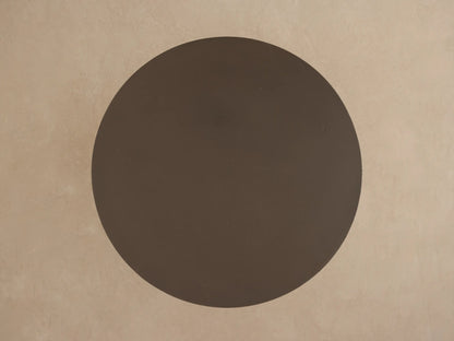Two dark brown Cascade Outdoor Coffee Tables, round tops with column legs. Larger table behind smaller one on light beige.