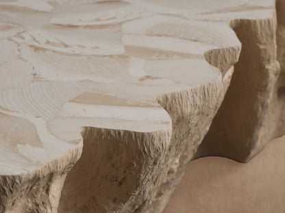 Clayhill Outdoor Coffee Table, light beige, with an organic, rough rock-like texture and irregular shape, on a tiled floor.