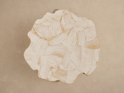 Clayhill Outdoor Tapered End Table, a cream-colored tree stump-like table with an irregular top of swirling natural veneers.