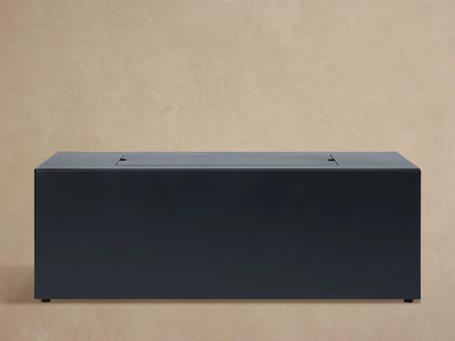 Coden Rectangular Natural Gas Fire Pit's light gray protective cover, with a front label, shown against a tan background.