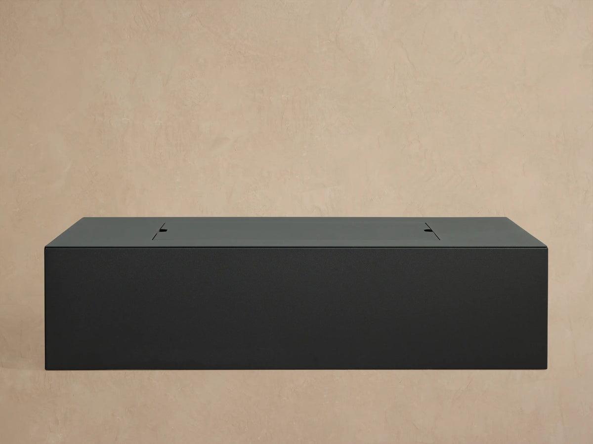 Close-up of matte dark gray Coden Rectangular Propane Fire Pit, filled with lava rocks, showing control knob & vent.