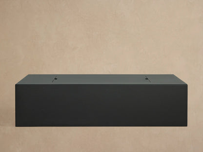 Close-up of matte dark gray Coden Rectangular Propane Fire Pit, filled with lava rocks, showing control knob & vent.