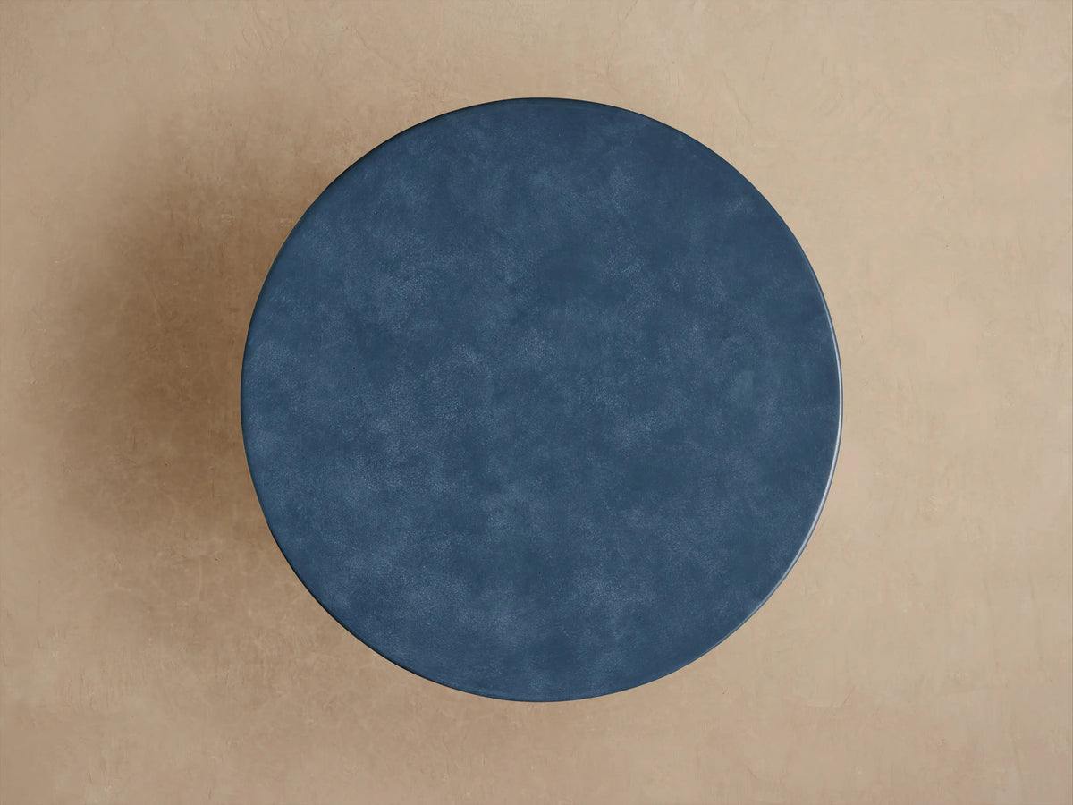 Close-up of a dark blue Colorno Outdoor End Table, revealing its mottled surface texture and a shiny, lighter blue horizontal groove.