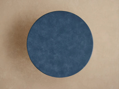 Close-up of a dark blue Colorno Outdoor End Table, revealing its mottled surface texture and a shiny, lighter blue horizontal groove.