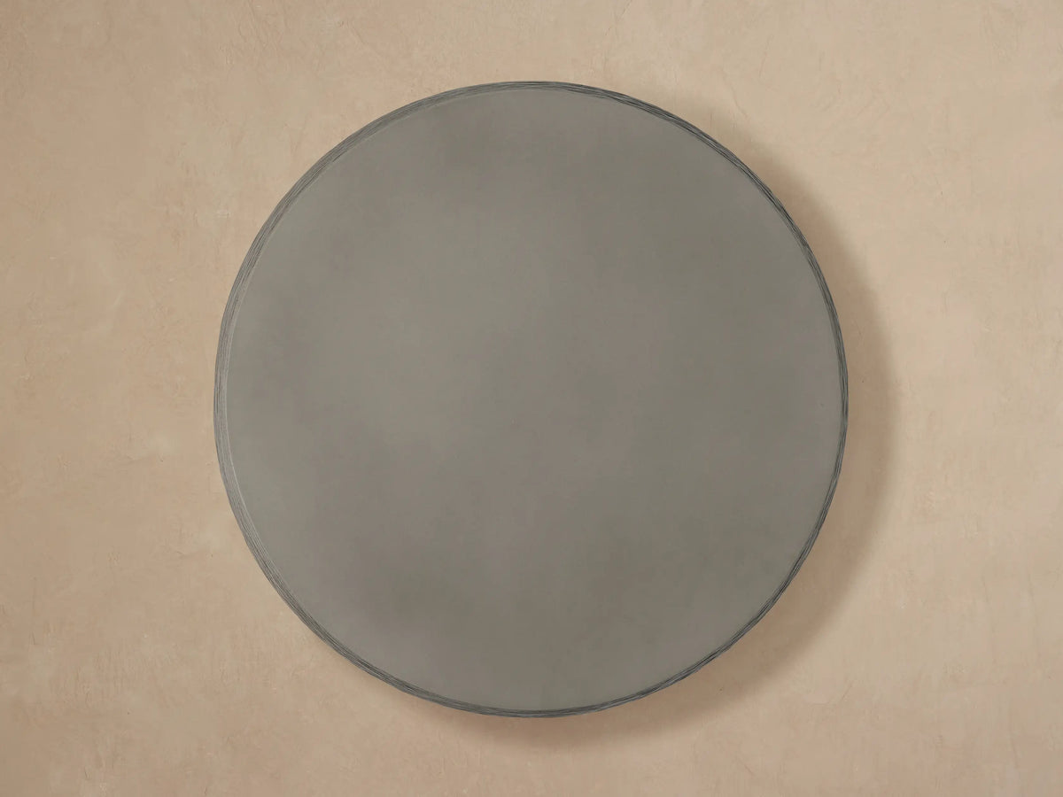 Close-up of a dark grey Eden Outdoor Round Coffee Table, featuring a smooth top and horizontally ribbed sides.