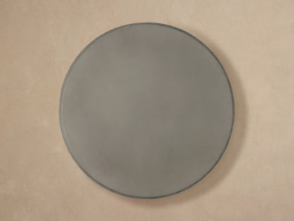 Close-up of a dark grey Eden Outdoor Round Coffee Table, featuring a smooth top and horizontally ribbed sides.