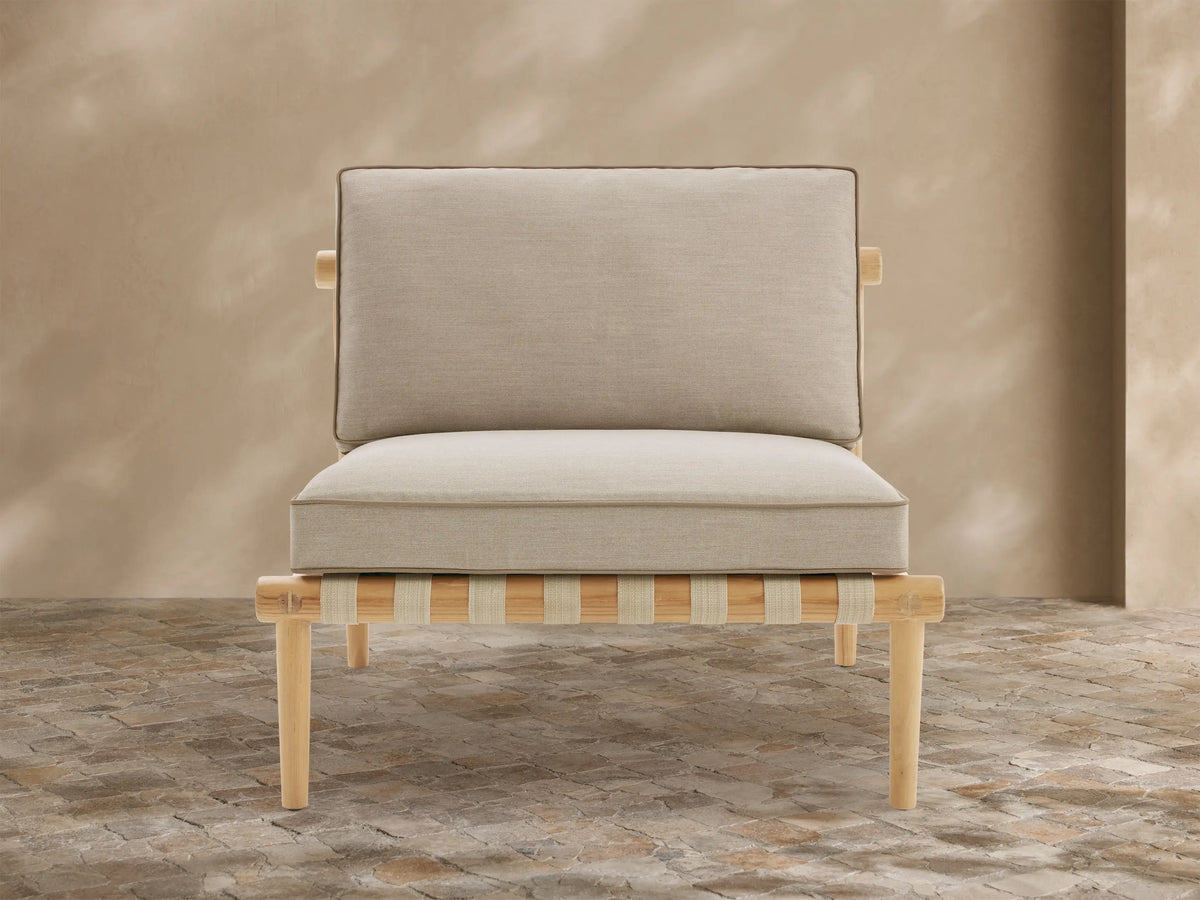 Elio Outdoor Collection Cover, light gray Agora fabric, draped smoothly over an outdoor chair, with a vertical seam at the front.