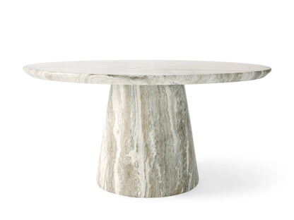 Round Edgewater Outdoor Dining Table. Faux marble top with white, grey, and brown veining, centered on beige.