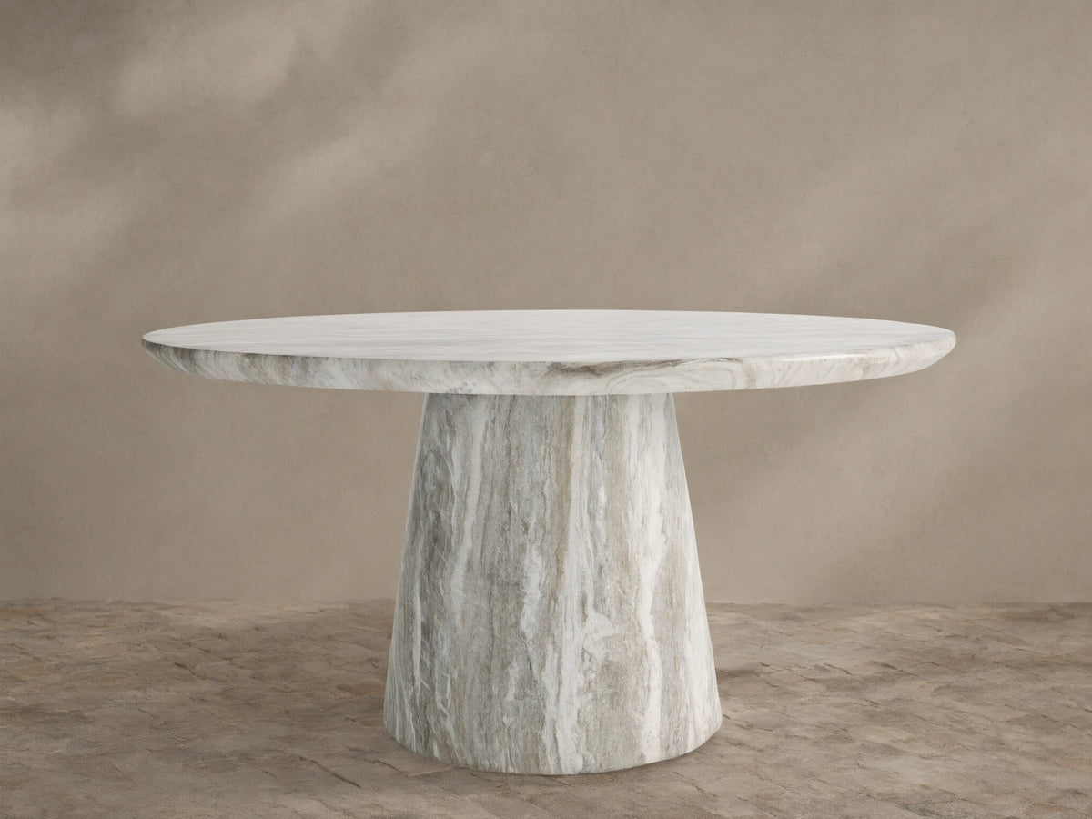 Edgewater Outdoor Dining Table, round jade faux marble top with grey veining, tapered base, on a brick patio.