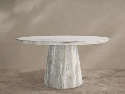 Edgewater Outdoor Dining Table, round jade faux marble top with grey veining, tapered base, on a brick patio.