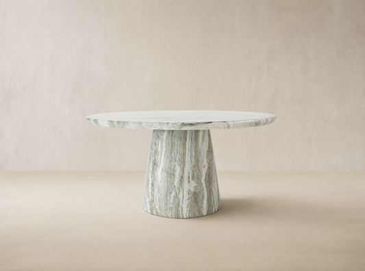 Edgewater Outdoor Dining Table, round jade faux marble top with grey veining, tapered base, on a brick patio.