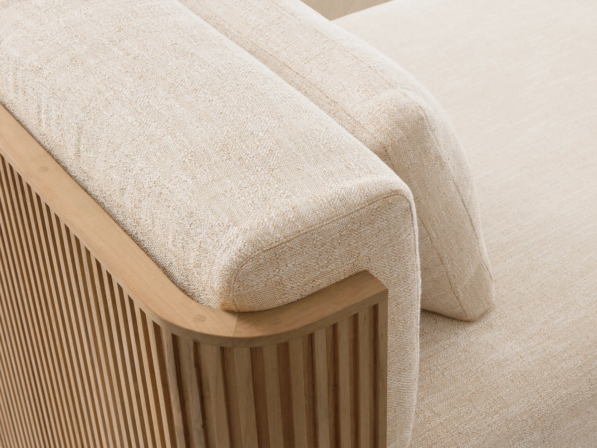 Beaumont Outdoor Teak Three-Piece Modular Sofa with light beige cushions on a slatted teak wood base, outdoors.