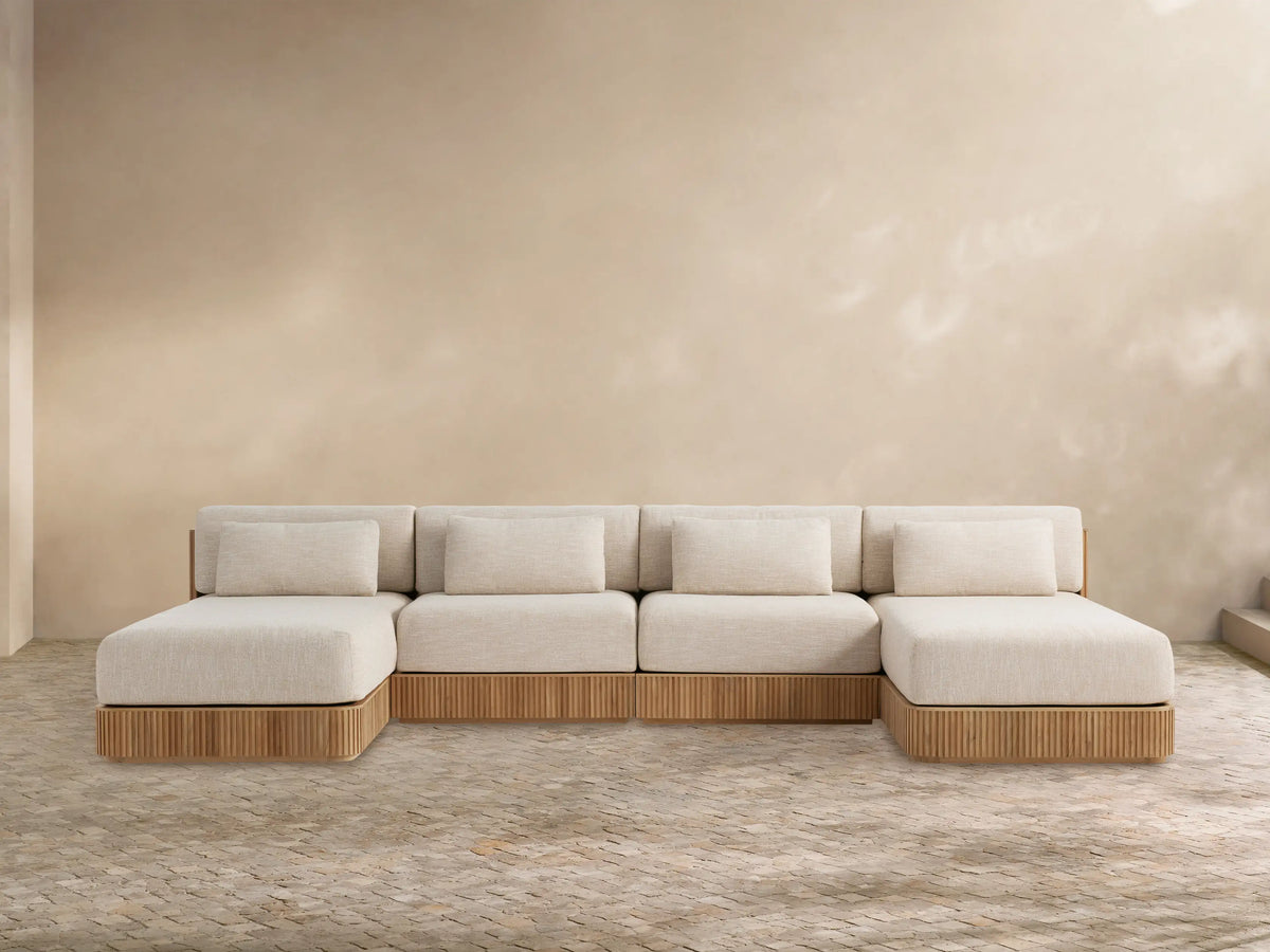 Front view of Beaumont Outdoor Four-Piece Double Chaise Sectional, with light beige cushions and slatted teak wood base.